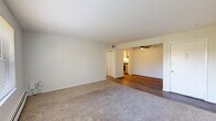 Located at 3284 Rocker Dr in Cincinnati, Ohio, this single-floor home offers three bedrooms, two bathrooms, a kitchen, living room, and a utility room within a well-organized layout. The interior features a clean, neutral color palette with white walls throughout, creating a bright and cohesive atmosphere. Wood-look plank flooring runs through the main living areas, kitchen, and bathrooms, while plush carpet covers all three bedrooms for added comfort. The spacious primary bedroom is notably generous in size, with a large window that invites natural light and views of the surrounding greenery, complemented by a double-door closet providing ample storage. The additional bedrooms are similarly well-lit, each featuring windows with outdoor views and baseboard heating. The kitchen is equipped with marble-look countertops and includes an access panel on the wall. Two bathrooms serve the home: one full bath featuring a shower-tub combo with built-in shelving and a vanity, and a second bath with a toilet and towel bar. A utility room adds practical functionality. The living area transitions seamlessly between wood-look and carpeted flooring, anchored by a large window that fills the space with natural light.