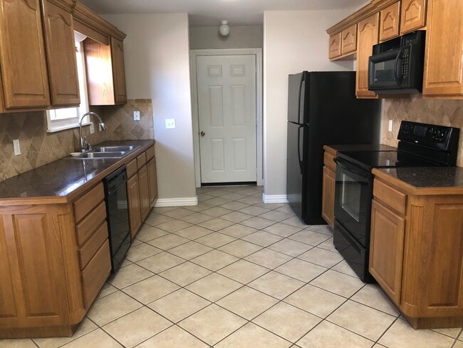 Kitchen view toward garage entry and utility area - 6188 W Milliken Bnd