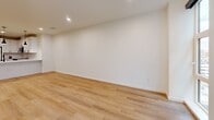 Located at 955 Bannock St in Denver's vibrant Golden Triangle neighborhood, this modern one-bedroom, one-bathroom residence offers a thoughtfully designed single-floor layout with a clean, contemporary aesthetic throughout. Light-toned hardwood flooring flows seamlessly across every room, creating a cohesive and airy atmosphere.

The open-concept kitchen and living area serves as the heart of the home. The kitchen is outfitted with crisp white shaker cabinetry, quartz countertops, and a full suite of stainless steel appliances, including a range, over-the-range microwave, dishwasher, and refrigerator. Black hardware accents and a sleek pendant light add modern contrast, while a peninsula counter provides additional workspace and a natural division between the kitchen and living area.

The bedroom is a well-proportioned retreat featuring large windows that frame views of the surrounding urban architecture and allow natural light to fill the space. A distinctive exposed concrete column adds an industrial touch to the otherwise soft, neutral palette. A dedicated closet provides practical storage.

The bathroom showcases a frameless glass-enclosed walk-in shower, a white vanity with stone countertop, and black fixture accents that tie together the modern design language found throughout the residence. Recessed lighting and clean tile flooring complete the polished look.