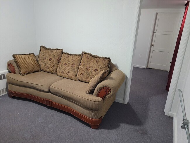 Living room with couch and view into bedroom - 481 S 100 E