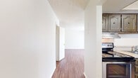 This 880 square foot apartment, located in Summit West - 12F - B1, offers a well-designed living space with two bedrooms and one bathroom. The unit features a single-story layout, maximizing the use of available space. The primary bedroom is generously sized at 190 square feet, providing ample room for rest and relaxation.

Throughout the apartment, warm wood flooring adds a touch of elegance and continuity. Large windows in the living areas and bedrooms allow for abundant natural light, creating a bright and airy atmosphere. Vertical blinds offer privacy and light control when needed.

The kitchen, while compact, is efficiently designed with wooden cabinetry, providing ample storage. Stainless steel appliances, including a refrigerator and dishwasher, offer modern convenience. A ceiling fan in the main living area helps with air circulation and comfort.

The apartment's layout includes a hallway connecting the various rooms, enhancing the sense of space and privacy. Built-in closets in the bedrooms provide valuable storage solutions. The overall neutral color palette of white walls and ceilings creates a clean, fresh backdrop that can easily accommodate various decor styles.

This apartment combines functionality with comfort, making it an ideal living space for those seeking a well-appointed home in a convenient location.