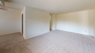 Located at 3400 Miller Rd in Wilmington, Delaware, this single-floor residence offers a practical and straightforward layout suited for comfortable everyday living. The living area is generously sized, finished with neutral wall-to-wall carpeting and bright white walls that create a clean, open atmosphere. A large window allows natural light to fill the space while providing views of the surrounding outdoor scenery, and a door provides convenient exterior access.

The bedrooms continue the same neutral carpet flooring and light-toned walls, offering well-proportioned spaces with closet storage. Each room is laid out to maximize usability, with good natural light coming through windows fitted with blinds.

The kitchen is equipped with dark wood cabinetry both above and below the counters, offering ample storage space. White countertops provide a functional work surface, and a stainless steel single-basin sink is positioned conveniently within the layout. Additional counter space extends along the wall, complemented by overhead cabinets, making the kitchen practical for daily use. Tile flooring in the kitchen adds durability to this high-traffic area.

The bathroom features a full-size soaking tub with a tiled surround in classic white, paired with chrome fixtures, providing a clean and functional design. Overall, this residence presents a well-maintained, functional living environment in Wilmington, DE.