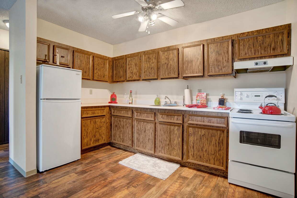 A kitchen with lots of cabinetry and ceiling fan - Carlton Park