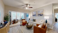 Located in Spanish Fort, Alabama, this single-floor 2-bedroom, 2-bathroom residence offers a thoughtfully designed layout with comfortable, modern finishes throughout. The spacious living room serves as the heart of the home, featuring wood-look flooring, a ceiling fan with light fixture, and a large bank of windows that flood the space with natural light. Neutral wall tones and an open flow into the entryway create a welcoming and airy ambiance.

The galley-style kitchen is outfitted with crisp white cabinetry, granite countertops, black appliances, and wood-look flooring, offering both style and functionality in an efficient layout.

The primary bedroom is generously sized, featuring plush carpet, a ceiling fan, natural light from a large window, and direct access to a closet and en-suite bathroom. The second bedroom is equally well-appointed with carpet flooring and easy access to the hallway. Both bathrooms are finished with granite vanity tops, white cabinetry, and tub-shower combinations with clean, classic tile surrounds.

Additional highlights include three closets for ample storage, a connecting hallway that links all rooms seamlessly, and a consistent neutral color palette that lends a polished, cohesive feel to the entire residence.