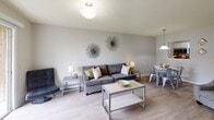 Located at 420 Racine Dr in Wilmington, North Carolina, this single-floor residence offers a well-designed layout with a thoughtful blend of comfort and functionality. The open-concept living and dining area is bright and welcoming, featuring light wood-style flooring, neutral gray walls, and a textured ceiling. The space is versatile and accommodating, with room for both relaxed lounging and dining. Adjacent to the living area, the kitchen is efficiently laid out with white cabinetry, dark countertops, a double stainless steel sink, a built-in dishwasher, and a stainless steel refrigerator — providing ample storage and workspace for everyday cooking. The residence includes two well-proportioned bedrooms, each carpeted for warmth and comfort. Both rooms feature ceiling fans with light fixtures and windows fitted with horizontal blinds that allow for natural light and privacy. The bathrooms are clean and functional, each equipped with a full shower-tub combination and classic chrome fixtures. The overall design throughout the home maintains a consistent neutral palette, creating a cohesive and move-in ready environment. Situated in Wilmington, NC, the property benefits from convenient access to local amenities and the coastal lifestyle the area is known for.