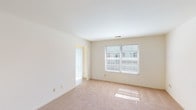Located at 5545 Westwood Northern Blvd in Cincinnati, Ohio, this single-floor residence offers a practical and functional layout designed for comfortable everyday living. The interior is characterized by neutral cream-toned walls and soft wall-to-wall carpeting throughout the living and bedroom areas, creating a clean and cohesive aesthetic.

The living area is generously sized, featuring large windows fitted with horizontal blinds that allow abundant natural light to fill the space. A sliding glass door with vertical blinds provides access to an adjacent area, enhancing the open feel of the main living space.

The kitchen is efficiently designed with warm oak cabinetry offering ample upper and lower storage, light-toned laminate countertops, and dark tile flooring. It is equipped with a white electric coil-burner range with an overhead ventilation hood, a double-basin stainless steel sink, a dishwasher, and a full-size refrigerator — providing all essential appliances for daily use.

Multiple bedrooms are present throughout the unit, each featuring plush carpeting and windows that frame views of surrounding greenery, bringing in natural light and a sense of connection to the outdoors. The overall layout, as visible from the dollhouse view, reflects a well-organized single-level floor plan with clear room separation and efficient use of space.