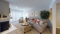This single-floor residence offers a thoughtfully arranged layout that balances comfort and functionality across its key living areas. The living room is generously sized, finished with neutral-toned carpet and smooth ceilings, and benefits from abundant natural light streaming through large vertical-blind-covered sliding doors. The open, airy atmosphere is further enhanced by soft wall tones that carry throughout the home.

The galley-style kitchen is efficiently designed with warm wood cabinetry lining both walls, speckled countertops, a double stainless steel sink, and black appliances including a range and refrigerator. A window above the counter brings in natural light and views of outdoor greenery. Adjacent to the kitchen, the dining area accommodates a round table seating four and features recessed ceiling lighting and access to additional natural light through a sliding door.

The bedroom is carpeted and comfortably scaled, with a window providing natural light and a walk-in closet offering ample storage. The primary bathroom presents an elongated vanity with speckled countertops, warm wood cabinetry, and hardwood-style flooring, while a separate tiled tub-shower combination and hardwood-style floors complete the secondary bath. Neutral tones and consistent finishes create a cohesive, understated ambiance throughout.