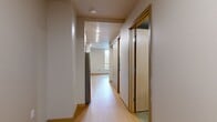 This contemporary apartment offers a well-designed living space of 760 square feet, efficiently accommodating three bedrooms and one bathroom. The primary bedroom, measuring 110 square feet, provides a comfortable retreat. The open-concept living area is highlighted by large windows that flood the space with natural light, creating an airy ambiance. Sleek bamboo flooring runs throughout the main living spaces, while plush carpeting adds warmth to the bedrooms.

The kitchen showcases modern amenities, including stainless steel appliances, wood-grain cabinetry, and quartz countertops. A built-in microwave and ample storage optimize functionality. The bathroom features a clean design with a wood vanity and a combination tub-shower.

Ample closet space in the bedrooms, including sliding door options, offers generous storage solutions. The apartment's neutral color palette provides a versatile backdrop for various decorating styles. Recessed lighting and baseboard heating contribute to the overall modern aesthetic and comfort of this urban dwelling. Located in Seattle's vibrant University District, this apartment combines contemporary living with a prime location.