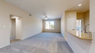 Located at 80175 Avenue 52 in La Quinta, California, this single-story 2-bedroom, 2-bathroom home offers a comfortable and functional layout. The open living room features plush carpeting, a ceiling fan, and a window that fills the space with natural light, creating a bright and airy atmosphere. Adjacent to the living area, the kitchen is outfitted with warm wood cabinetry, granite-style countertops, stainless steel appliances including a gas range and built-in microwave, and tile flooring — providing a practical and attractive space for cooking. The generously sized primary bedroom includes a ceiling fan, carpeted floors, and ample natural light, accompanied by a walk-in closet with built-in shelving for organized storage. The second bedroom also features carpeting and a ceiling fan. Two full bathrooms serve the home, each offering a tub-shower combination, vanity with granite-style countertop, and hardwood-style flooring. Three closets total are distributed throughout the home, enhancing storage capacity. Neutral tones, consistent finishes, and a clean, straightforward design define the overall character of this La Quinta residence.