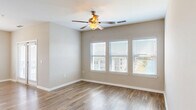 Located at 915 Brentmoor Dr in Myrtle Beach, SC, this well-appointed single-story home offers 2 bedrooms and 2 bathrooms within a thoughtfully designed floor plan. The open-concept living, dining, and kitchen area serves as the heart of the home, bathed in natural light from large windows with blinds and complemented by wood-look flooring throughout. Ceiling fans are featured in multiple rooms for added comfort. The kitchen is outfitted with rich dark cabinetry, granite countertops, stainless steel appliances including a range and over-the-range microwave, a classic white tile backsplash, and a pantry for additional storage. A hallway with built-in shelving connects the main living area to the private quarters. The primary bedroom is generously sized, featuring wood-look flooring, a ceiling fan, and ample natural light from a bank of three windows. It is accompanied by a walk-in closet with wire shelving. The second bedroom is carpeted, includes a ceiling fan, and offers two windows overlooking the exterior. Both bathrooms are finished with dark vanities, granite countertops, and wood-look flooring. Additional conveniences include a dedicated laundry area and utility room, rounding out a functional and attractive home.