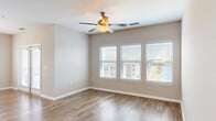 Located at 915 Brentmoor Dr in Myrtle Beach, SC, this well-appointed single-story home offers 2 bedrooms and 2 bathrooms within a thoughtfully designed floor plan. The open-concept living, dining, and kitchen area serves as the heart of the home, bathed in natural light from large windows with blinds and complemented by wood-look flooring throughout. Ceiling fans are featured in multiple rooms for added comfort. The kitchen is outfitted with rich dark cabinetry, granite countertops, stainless steel appliances including a range and over-the-range microwave, a classic white tile backsplash, and a pantry for additional storage. A hallway with built-in shelving connects the main living area to the private quarters. The primary bedroom is generously sized, featuring wood-look flooring, a ceiling fan, and ample natural light from a bank of three windows. It is accompanied by a walk-in closet with wire shelving. The second bedroom is carpeted, includes a ceiling fan, and offers two windows overlooking the exterior. Both bathrooms are finished with dark vanities, granite countertops, and wood-look flooring. Additional conveniences include a dedicated laundry area and utility room, rounding out a functional and attractive home.