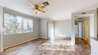 This two-story home in Antioch, CA (94531) offers a well-designed layout with functional living spaces spread across both levels. The main living area is bright and open, featuring warm wood-style flooring, crown molding, and a ceiling fan with light fixture. Natural light streams in through large windows dressed with vertical blinds, and a fireplace with a classic white mantle serves as a focal point. Access to an outdoor area is provided through sliding vertical-blind panels.

The kitchen is thoughtfully equipped with white cabinetry, a center island featuring a dark countertop with a built-in sink, and a full suite of stainless steel appliances, including a refrigerator, range, and microwave. Adjacent to the kitchen is a dedicated laundry area with an in-unit washer.

The bedrooms feature plush carpeting and ample natural light, with one room offering a generous walk-in closet complete with wire shelving. The bathroom includes a full soaking tub and shower combination with tiled surround.

Additional highlights include an attached garage with an automatic opener, providing secure parking and extra storage. The neutral color palette and clean finishes throughout create a move-in ready environment suited for comfortable everyday living.