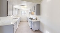 Located at 39058 Agua Vista in Murrieta, CA, this single-story, one-bedroom, one-bathroom residence offers a practical and efficient layout across its single floor. The open-concept living, dining, and kitchen area forms the heart of the home, bathed in natural light from a large sliding glass door that leads directly to a private patio with outdoor views — an ideal spot for relaxing or entertaining. Light wood-style flooring runs throughout the main living areas and bedroom, complemented by a textured ceiling that adds a classic touch. A ceiling fan in the kitchen/dining area enhances airflow and comfort.

The galley-style kitchen is well-appointed with gray cabinetry, light countertops, a gas range, and ample upper and lower cabinet storage. A window above the sink brings in additional natural light. The bedroom is a comfortable, well-proportioned space featuring a bright window with blinds, access to closet space, and the same light flooring found throughout. The bathroom includes a full tub and shower combination with a clean, white finish. Additional utility rooms and a hallway provide functional storage and connectivity. The overall ambiance is bright, clean, and move-in ready.