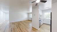 Located at 318 N Sage St in Kalamazoo, Michigan, this two-bedroom, one-bathroom single-floor home offers a clean, modern aesthetic with thoughtfully updated finishes throughout. The interior is defined by warm, light wood luxury vinyl flooring that runs consistently across every room, complementing the crisp white walls and creating a bright, cohesive feel.

The living room is a generous open space featuring a ceiling fan with light fixture and bold black interior doors that provide a stylish contrast against the white walls. Natural light filters in through well-placed windows, and a baseboard heating system ensures year-round comfort.

The primary bedroom is a well-proportioned room equipped with a ceiling fan, a large window with views of the surrounding greenery, and baseboard heating. The second bedroom mirrors this bright, airy quality, with its own window and a full-panel bifold closet offering ample storage space.

The bathroom is cleanly finished with white tile surround, a full tub-shower combination featuring matte black fixtures, a window for natural light and ventilation, and the same light wood flooring carried throughout the home.

A kitchen area visible in the floorplan model features white cabinetry and appliances. The overall layout is efficient and well-organized, making this Kalamazoo home a comfortable and attractive living space.