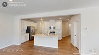 Located in Durham, NC, this well-designed two-story home offers 3 bedrooms, 4 bathrooms, and a thoughtful layout spread across two floors. The ground floor opens into a bright, open-concept kitchen and living area finished with warm hardwood-style flooring. The kitchen is a standout, featuring white shaker cabinetry extending to the ceiling, light quartz countertops, a subway tile backsplash, stainless steel appliances including a French door refrigerator and range, and a central island with a sink — ideal for both cooking and entertaining. The living area is bathed in natural light from multiple windows. An attached garage with an automatic opener provides convenient interior access. Upstairs, the generously sized primary bedroom includes a tray ceiling and plush carpeting, accompanied by a walk-in closet outfitted with wire shelving. Two additional bedrooms, also carpeted, share access to well-appointed bathrooms featuring tile flooring, tub-shower combinations, and white vanities. A dedicated upstairs laundry room houses a full-size washer and dryer with overhead shelving for added storage. Neutral tones and recessed lighting throughout give the home a clean, modern aesthetic.