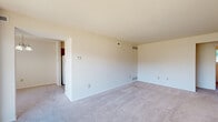 Located on Ashton Road in York, PA, this well-organized 2-bedroom, 1-bathroom residence makes efficient use of its single-floor layout. The living room is bright and open, finished with neutral carpet and large sliding glass doors that lead to a private balcony overlooking the surrounding neighborhood, filling the space with natural light. Adjacent to the living room, the dining area features a classic chandelier and a wide window that further brightens the space.

The galley-style kitchen is equipped with warm wood cabinetry, laminate stone countertops, and hardwood-style flooring. A doorway off the kitchen opens directly into a dedicated utility room housing a full-size washer and dryer, adding everyday convenience.

The spacious primary bedroom offers generous room to furnish comfortably, with soft carpet, ample wall space, and easy access to the full bathroom. The second bedroom also features carpeting and a large window with outdoor views, along with an adjacent closet. Two closets throughout the unit provide practical storage solutions.

The full bathroom includes a single-sink vanity with a marble-style countertop, a tiled soaking tub and shower combination, and a window for natural ventilation. Throughout the residence, a neutral color palette and consistent finishes create a clean, cohesive aesthetic.
