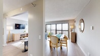 Located in the heart of Chicago's vibrant Lincoln Park neighborhood, this well-appointed one-bedroom, one-bathroom residence offers an efficient and thoughtfully designed layout across a single floor. Light wood flooring flows throughout the main living areas, complemented by neutral tones that create a clean, modern aesthetic.

The open living and dining area is a standout space, anchored by expansive floor-to-ceiling windows and a private balcony that frame sweeping views of the Chicago skyline and beyond. Natural light pours in generously, enhancing the airy feel of the room.

The kitchen features white shaker cabinetry, a subway tile backsplash, light countertops, and a full suite of stainless steel appliances, including a range, microwave, dishwasher, and refrigerator — offering both style and function in a compact footprint.

The spacious primary bedroom is carpeted for comfort and boasts its own large windows with continued city views, a generous closet, and ample room for a full furniture arrangement. The bathroom is finished with white tile flooring, a white vanity with dark countertop, and a shower-tub combination. Every room reflects a cohesive, contemporary design sensibility suited to urban living in one of Chicago's most sought-after neighborhoods.