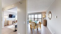 Located in the heart of Chicago's vibrant Lincoln Park neighborhood, this well-appointed one-bedroom, one-bathroom residence offers an efficient and thoughtfully designed layout across a single floor. Light wood flooring flows throughout the main living areas, complemented by neutral tones that create a clean, modern aesthetic.

The open living and dining area is a standout space, anchored by expansive floor-to-ceiling windows and a private balcony that frame sweeping views of the Chicago skyline and beyond. Natural light pours in generously, enhancing the airy feel of the room.

The kitchen features white shaker cabinetry, a subway tile backsplash, light countertops, and a full suite of stainless steel appliances, including a range, microwave, dishwasher, and refrigerator — offering both style and function in a compact footprint.

The spacious primary bedroom is carpeted for comfort and boasts its own large windows with continued city views, a generous closet, and ample room for a full furniture arrangement. The bathroom is finished with white tile flooring, a white vanity with dark countertop, and a shower-tub combination. Every room reflects a cohesive, contemporary design sensibility suited to urban living in one of Chicago's most sought-after neighborhoods.