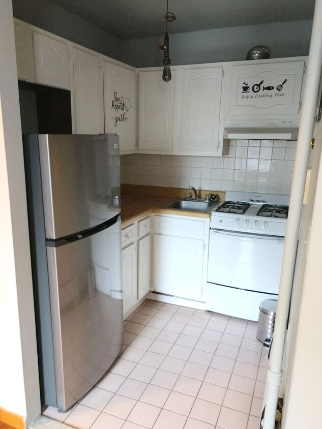 Kitchen with new refrigerator - 240 E 23rd St
