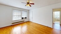 Located at 2665 Rivermont Ave in Lynchburg, Virginia, this 1-bedroom, 1-bathroom unit offers a thoughtfully arranged single-floor layout with classic architectural details throughout. Warm hardwood floors run through the living room, dining room, and bedroom, lending a sense of continuity and timeless character to the space.

The living room is bright and open, featuring crown molding and a ceiling fan. Adjacent to it, the dining room is highlighted by a vintage-style chandelier and large windows that invite ample natural light, with baseboard heating along the walls. The two rooms connect fluidly, creating a generous common area well-suited for everyday living.

The bedroom is generously sized, with two windows fitted with window-unit air conditioning and baseboard heat, a ceiling fan, and crown molding that echoes the rest of the unit's classic styling.

The kitchen features white cabinetry, ample counter space, a white electric range, and earthy ceramic tile flooring. A window at the far end allows natural light to brighten the cooking space, and a passage leads to additional utility areas.

The bathroom includes classic penny tile flooring, a full bathtub, and a window for ventilation. A hallway connects the rooms, completing this well-laid-out and characterful home in the heart of Lynchburg.