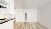Located at 12520 Lakewood Blvd in Downey, CA, this efficiently designed 1-bedroom, 1-bathroom unit offers a clean, modern aesthetic throughout its single floor. Light wood-look flooring runs continuously across all rooms, lending a cohesive and contemporary feel to the entire space.

The open-concept living, dining, and kitchen area makes excellent use of the available floor space. The kitchen is a standout feature, showcasing crisp white shaker cabinets, striking black marble-style countertops with contrasting veining, a black matte faucet, and a gas range. A pass-through counter connects the kitchen to the dining and living area, which is brightened by natural light and equipped with a ceiling fan and a wall-mounted heater unit.

The bedroom is a comfortable, well-proportioned room featuring a ceiling fan, a window with blinds for natural light and privacy, and access to a dedicated closet. An additional closet provides supplementary storage in the hallway.

The bathroom is tastefully finished with a white vanity cabinet topped with a bold black marble countertop, black hardware accents, a mirror, and a full tub/shower combo with a window above for natural ventilation. Textured ceilings are present throughout, adding a classic touch to the otherwise modern interior.