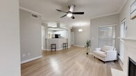 Located at 17671 Addison Rd in Dallas, TX, this 2-bedroom, 3-bathroom home offers a well-designed layout across a single floor. The open-concept living and kitchen area serves as the heart of the home, featuring light wood-style flooring, crown molding, and a ceiling fan that enhances airflow and comfort. The kitchen is outfitted with white shaker cabinetry, white quartz countertops, stainless steel appliances including a refrigerator, dishwasher, and range, plus a convenient breakfast bar that connects seamlessly to the living space. Natural light fills the interior through multiple windows dressed with blinds. Both bedrooms are generously sized, each equipped with ceiling fans and windows that bring in natural light. The primary bedroom includes a well-appointed en-suite bathroom featuring a white vanity, a large mirror with bright vanity lighting, and a glass-enclosed shower. Closets with hanging storage offer practical organization. The three bathrooms maintain a clean, neutral aesthetic with light wood-style flooring throughout. Additional highlights include a dedicated laundry area, a staircase, and an attached private garage with an automatic opener and a sealed concrete floor.
