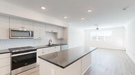 Located at 36101 Inland Valley Drive in Wildomar, CA, this thoughtfully designed one-bedroom, one-bathroom residence offers a clean, modern aesthetic across a single floor. The open-concept layout seamlessly connects the kitchen and living room, maximizing the sense of space and encouraging easy movement throughout.

The kitchen is a standout feature, showcasing crisp white cabinetry with matte black hardware, striking dark quartz countertops with white veining, and a textured tile backsplash. A central island provides additional prep space and casual seating potential. Stainless steel appliances, including a gas range, over-the-range microwave, dishwasher, and refrigerator, complete the well-appointed culinary space. Recessed lighting illuminates the area efficiently.

Light wood-look flooring extends throughout the home, creating a warm, cohesive feel. The living room receives natural light through a window fitted with blinds and is equipped with a ceiling fan. The bedroom is a comfortable, well-proportioned retreat with a window offering exterior views, a ceiling fan, and continued wood-look flooring.

The bathroom features white cabinetry with matching dark quartz countertops, a tub-shower combination, and a wall-mounted grab bar. A closet and hallway round out the functional layout of this well-designed Wildomar residence.
