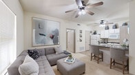 Located at 2800 SW Wagon Ave in Bentonville, AR, this two-bedroom, one-bathroom residence offers a thoughtfully designed single-floor layout that maximizes every square foot. The open-concept living and dining area flows seamlessly into the kitchen, creating a connected and functional living space. Plush carpeting and neutral wall tones lend a warm, inviting ambiance throughout, while ceiling fans in each room provide year-round comfort.

The kitchen is well-appointed with white cabinetry, dark granite-style countertops, tile flooring, a full suite of appliances, and a breakfast bar with seating — ideal for casual dining or entertaining. The living area offers generous wall space and natural light through window blinds, complementing the open feel of the layout.

Both bedrooms are carpeted and feature ceiling fans and windows that allow natural light to filter in. The primary bedroom is a comfortable retreat with a walk-in closet fitted with wire shelving for organized storage. The bathroom includes a vanity with white cabinetry, tile flooring, and a well-lit mirror. A dedicated laundry area adds everyday convenience, rounding out this practical and comfortable Bentonville residence.