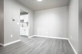 Located at 2421 Chalet Gardens Ct in Fitchburg, WI, this 2-bedroom, 1-bathroom residence offers a well-organized single-floor layout with a clean, modern aesthetic throughout. Luxury vinyl plank flooring flows consistently across the living spaces, complemented by neutral warm-gray walls and crisp white trim and doors.

The open living room provides generous space for entertaining or relaxing, with a sliding glass patio door that fills the area with natural light and offers outdoor access. The kitchen features white shaker-style cabinetry, granite-patterned countertops, a stainless steel refrigerator, and a built-in dishwasher — offering both function and style in a compact, efficient layout.

Both bedrooms are comfortably sized, with the primary bedroom offering a dedicated closet and ample room for furnishings. Each bedroom benefits from natural light via windows, and one features direct access to a closet with built-in hanging storage. A second closet provides additional storage convenience throughout the unit.

The full bathroom is outfitted with a tub/shower combination, updated brushed nickel fixtures, a white vanity, and wood-look flooring, creating a tidy and functional space. Baseboard heating is present throughout, ensuring consistent comfort year-round.