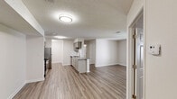 This single-floor, 2-bedroom, 2-bathroom residence in Birmingham, Alabama presents a clean, functional layout designed for comfortable everyday living. The open-concept main area seamlessly connects the living room, dining area, and kitchen, all finished with durable wood-look plank flooring and neutral-toned walls that create a bright, cohesive atmosphere. Textured ceilings run throughout the main living spaces, adding a classic touch.

The kitchen is well-appointed with gray cabinetry, granite countertops, a stainless steel sink, and a full suite of stainless steel appliances including a range, microwave, refrigerator, and dishwasher. A peninsula with a breakfast bar provides additional counter space and serves as a natural divide between the kitchen and living areas. Natural light flows into the living room through a window overlooking the exterior.

Both bedrooms feature plush carpeted floors and ceiling fans, offering a comfortable retreat. Each bedroom includes closet storage, with one bedroom featuring a walk-in closet equipped with wire shelving for organized storage. The bathrooms are finished with granite-topped vanities, gray cabinetry, wood-look flooring, and a tub-shower combination. Two dedicated closets provide ample storage throughout the residence.