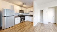 Located at 5940 San Fernando Rd in Glendale, California, this one-bedroom, one-bathroom unit offers a thoughtfully designed single-floor layout that maximizes its compact footprint. Wood-look luxury vinyl flooring runs consistently throughout the space, lending warmth and visual continuity across every room.

The kitchen is a standout feature, equipped with stainless steel appliances including a gas range, over-the-range microwave, and refrigerator. Crisp white shaker cabinetry provides ample storage, complemented by dark countertops and a stainless steel sink. Track lighting and a textured ceiling complete the kitchen's clean, functional aesthetic.

The bedroom offers a comfortable and well-proportioned space with a ceiling fan, a large sliding-door closet for storage, and a window that allows natural light to filter in. Its white walls and neutral tones create a calm, versatile atmosphere.

The bathroom features a tiled tub-and-shower combination with large-format beige tile surround, a frosted window above for natural light and privacy, wood-look flooring, and vanity with a quartz-style countertop and brushed nickel hardware throughout.

Overall, the unit presents a clean, modern aesthetic with updated finishes suited for efficient, comfortable living in the Glendale area.