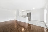 Located at 2360 Weston Rd in Toronto's Weston neighbourhood, this one-bedroom, one-bathroom unit offers a practical and well-organized single-floor layout. The combined kitchen and living area forms the heart of the unit, where a galley-style kitchen stands out with its clean white cabinetry, white subway tile backsplash, light tile flooring, and stainless steel appliances including a full-size refrigerator, microwave, and stove. The open living room beyond the kitchen features richly toned parquet hardwood flooring that extends throughout the main living and sleeping areas, adding warmth and character to the bright, white-walled interiors. A window overlooking the outdoors allows natural light to filter in, enhancing the airy feel of the space. The bedroom is a comfortable size, offering a double-door closet for generous storage and its own window with outdoor views, along with a baseboard heating unit. The bathroom is finished in a clean, minimalist style with white tile walls, a vanity with a square sink, a large mirror, and a combined tub and shower. Throughout the unit, white walls and trim create a fresh, neutral palette that is easy to personalize. The textured ceiling in the living area adds a subtle architectural detail to the overall design.