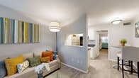 This single-story residence at 1679 W Brampton Way in Salt Lake City, UT offers a well-organized layout designed for comfortable everyday living. The living room serves as the heart of the home, featuring light wood-style flooring, a sliding glass door that welcomes abundant natural light, and direct access to an outdoor area. A pass-through window connects the living space to the kitchen, maintaining an open and connected feel throughout.

The kitchen is efficiently designed in a galley-style configuration, equipped with white cabinetry, dark granite-style countertops, a stainless steel sink, and stainless steel appliances including a refrigerator, range, and dishwasher. Light flooring continues through this space, enhancing its clean, functional aesthetic.

The bedrooms are carpeted for warmth and comfort, each offering closet storage and access to natural light through windows with blinds. The layout provides a clear sightline from the bedrooms through a hallway toward the main living areas, contributing to an open and airy atmosphere. The bathroom includes a full tub and shower combination with wood-look tile flooring and clean white finishes, keeping the space feeling fresh and practical throughout.