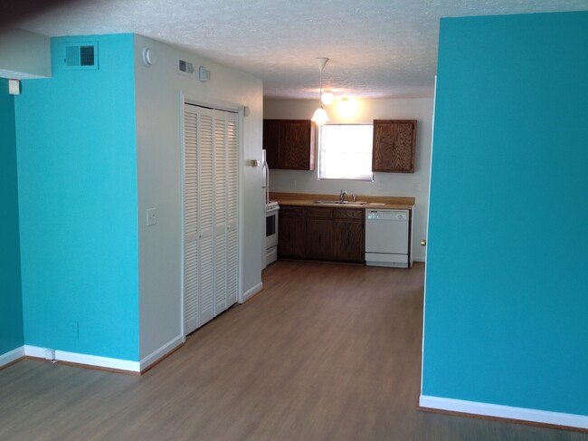 View from Living Room to Kitchen, washer/dryer closet on left, half bath on right wall. - 735 Park Cir