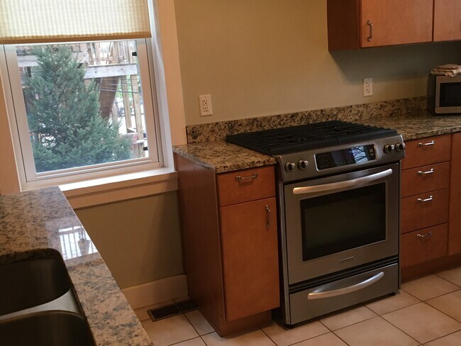 Kitchen with stainless steel appliances and countertops - 6511 San Bonita Ave