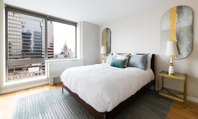 photo of 2 Gold St Model Apartment 4803 city view and bedroom staged with model furniture - 2 Gold St