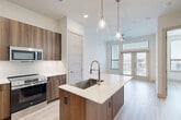 Located at 333 W 24th St in Houston, TX, this thoughtfully designed 2-bedroom, 2-bathroom home offers a bright and contemporary living experience on a single floor. Light wood-tone flooring flows consistently throughout, complementing the crisp white walls and clean architectural lines that define the interior aesthetic.

The open-concept kitchen and living area serves as the heart of the home. The kitchen features a generous island with a white quartz countertop, an undermount sink with a brushed gold faucet, white shaker cabinetry with gold hardware, a tile backsplash, and stainless steel appliances including a gas range, microwave, and French door refrigerator. Three glass pendant lights hang above the island, adding a refined touch. Multiple windows flood the adjoining living area with natural light and offer neighborhood views.

The spacious primary bedroom is well-proportioned, with two windows, a ceiling fan, and ample room to furnish comfortably. The second bedroom is equally bright, also featuring a ceiling fan and a large window with outdoor views. Both bedrooms include dedicated closets. The bathrooms are finished with marble-look tile flooring, white vanity cabinetry with stone countertops, and backlit mirrors, lending a polished, spa-like feel. The home also includes two closets for additional storage.