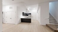 Located at 22 Schuyler Place in Morristown, NJ, this thoughtfully designed two-story residence offers 2 bedrooms and 3 bathrooms across two well-proportioned floors. The main level hosts a spacious open-concept kitchen and living area bathed in a clean, contemporary aesthetic. The kitchen is a standout feature, showcasing dark cabinetry with gold and brushed hardware, crisp white quartz countertops, a subway tile backsplash, and a full suite of stainless steel appliances including a gas range, refrigerator, dishwasher, and built-in microwave. A central island with pendant lighting anchors the space, flowing seamlessly into the living area with its light hardwood flooring and bright white walls. One bedroom on the main level features sliding glass doors that open to an outdoor area, inviting natural light and exterior views. The generously sized primary bedroom includes access to a walk-in closet with built-in shelving. The three bathrooms are finished to a high standard — one features a glass-enclosed walk-in shower with mosaic tile flooring and large-format wall tile, while another includes a soaking tub with full tile surround. The upper floor provides additional private living space, and multiple stairways connect the two levels with ease.
