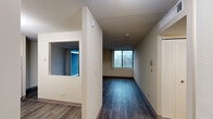 This one-bedroom, one-bathroom unit at 5441 N East River Rd in Chicago offers a well-organized, single-floor layout that makes efficient use of its space. The living room is a bright, open area featuring wood-style plank flooring in a cool gray tone and a large sliding glass door that floods the room with natural light and provides access to an outdoor area. Additional wide windows in the living space frame views of the surrounding Chicago neighborhood, enhancing the sense of openness. The kitchen is thoughtfully equipped with white cabinetry extending to the ceiling for ample storage, granite-style laminate countertops, a gas range, dishwasher, refrigerator, and a double sink — all finished in a cohesive, clean aesthetic with wood-style flooring that carries through from the main living area. The bedroom is a comfortable, private retreat with its own large window offering neighborhood views and warm wood-toned flooring. A dedicated closet provides practical storage. The bathroom is well-appointed with a full soaking tub and shower combination, a wide vanity with an integrated sink, a mirrored medicine cabinet, and classic white tile flooring. A hallway connects all rooms, providing a clear and functional flow throughout the unit.