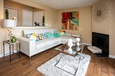 Located at 200 Highwood Ct in Knoxville, Tennessee, this single-floor home offers a well-organized layout with a welcoming entryway finished in warm hardwood flooring that carries throughout much of the residence. The foyer features a louvered closet and opens naturally into the main living areas.

The living room is a comfortable gathering space anchored by a fireplace and accented with a textured ceiling. Sliding glass doors lead directly to a private balcony overlooking mature trees, filling the room with natural light and greenery. Adjacent to the living room, a dining area with track lighting provides a defined space for meals.

The kitchen is equipped with warm wood cabinetry, granite countertops, a stainless steel sink, and full appliance package including a refrigerator. The granite surfaces and classic cabinetry lend a polished, functional feel to the space.

Multiple bedrooms are present throughout the home. Each room features windows that invite natural light, with one bedroom offering carpet flooring and a walk-in closet, while another presents hardwood-style flooring. Both bathrooms include wood vanities with granite countertops and tub/shower combinations, maintaining a consistent, quality finish throughout.

The overall ambiance of the home is warm and inviting, with cohesive finishes tying each space together seamlessly.