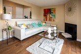 Located at 200 Highwood Ct in Knoxville, Tennessee, this single-floor home offers a well-organized layout with a welcoming entryway finished in warm hardwood flooring that carries throughout much of the residence. The foyer features a louvered closet and opens naturally into the main living areas.

The living room is a comfortable gathering space anchored by a fireplace and accented with a textured ceiling. Sliding glass doors lead directly to a private balcony overlooking mature trees, filling the room with natural light and greenery. Adjacent to the living room, a dining area with track lighting provides a defined space for meals.

The kitchen is equipped with warm wood cabinetry, granite countertops, a stainless steel sink, and full appliance package including a refrigerator. The granite surfaces and classic cabinetry lend a polished, functional feel to the space.

Multiple bedrooms are present throughout the home. Each room features windows that invite natural light, with one bedroom offering carpet flooring and a walk-in closet, while another presents hardwood-style flooring. Both bathrooms include wood vanities with granite countertops and tub/shower combinations, maintaining a consistent, quality finish throughout.

The overall ambiance of the home is warm and inviting, with cohesive finishes tying each space together seamlessly.