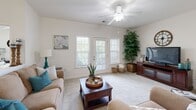 Located at 1140 Stafford Place Circle in Winston-Salem, North Carolina, this single-story residence offers a well-designed layout with comfortable living spaces and consistent finishes throughout. The living room is bright and welcoming, featuring plush carpeted floors, a ceiling fan, and a set of French doors flanked by windows that invite natural light and outdoor views. The galley-style kitchen is efficiently arranged with warm wood cabinetry, dark granite-style countertops, tile flooring, and black appliances including a refrigerator, range, and dishwasher. The primary bedroom is generously sized with carpet, a ceiling fan, multiple windows, and access to a walk-in closet. Additional bedrooms offer similar comfort with carpet, ceiling fans, and ample natural light through well-dressed windows. The bathrooms are cleanly finished, with wood vanities, white countertops, and tile flooring; one bathroom includes a shower-tub combination, while another features a dedicated vanity area. Throughout the home, a neutral color palette, consistent trim work, and practical design choices create a cohesive and functional living environment well-suited for everyday comfort.