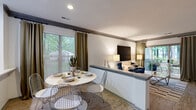 Located at 6316 Quail Hollow Rd in Charlotte, NC, this two-bedroom, two-bathroom single-floor home offers a well-designed layout with a comfortable and cohesive interior. Wood-look flooring flows through the entry, living, and dining areas, creating a warm and unified aesthetic throughout the main living spaces.

The living room is a standout, featuring a classic fireplace with a gray-painted mantel, sliding glass doors that open to a private outdoor patio, and lush tree views that bring natural light and greenery indoors. A half-wall partition neatly separates the dining area from the living room, maintaining an open-concept feel while defining each space.

The kitchen is appointed with rich dark cabinetry, light countertops, stainless steel appliances, and a window that frames garden views, keeping the space bright and functional.

Both bedrooms are carpeted and generously proportioned, each with large windows dressed in sheer curtains that allow abundant natural light. The primary bedroom offers a comfortable retreat with dedicated closet space.

The two bathrooms are clean and well-finished, each featuring a full tub-shower combination with tiled surrounds. Two additional closets throughout the home provide ample storage. The overall ambiance is bright, modern, and inviting.