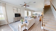 Located at 19302 Pradera Meadows Loop in Arcola, TX, this two-story home offers four bedrooms, four bathrooms, and a thoughtfully designed layout spread across two floors. The main level features a bright, open-concept living area with warm hardwood-style flooring, crown molding, and a ceiling fan, flowing seamlessly into the dining area and kitchen. The kitchen is equipped with white cabinetry, a subway tile backsplash, granite countertops, stainless steel appliances, and a peninsula with bar seating — ideal for casual dining and entertaining. Large windows throughout the main floor invite abundant natural light. A garage and laundry room round out the ground level. Upstairs, the home accommodates four well-proportioned bedrooms, including a generously sized primary suite with an en-suite bathroom. The secondary bedrooms feature plush carpeting, large windows with neighborhood views, and ample closet space. The bathrooms are finished with marble-style tile on both floors and walls, offering a clean, polished aesthetic. With five closets, two staircases, and a practical hallway connecting the upper rooms, this home balances comfort, functionality, and modern style throughout.