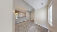 Located at 9123 Cleveland St in Merrillville, Indiana, this two-bedroom, two-bathroom two-story home offers a thoughtfully designed layout spread across two levels. The main living area showcases an open-concept kitchen and living room, where rich dark-wood cabinetry, granite countertops, a breakfast bar with pendant lighting, and stainless steel appliances create an inviting and functional hub. Plush wall-to-wall carpeting flows throughout the living and bedroom spaces, lending warmth and comfort to the interior's neutral, beige-toned palette.

The generously sized primary bedroom features a ceiling fan, a large window with views of the surrounding greenery, and access to a dedicated walk-in closet outfitted with wire shelving and hanging rods for ample storage. The second bedroom is well-proportioned with its own window that draws in natural light. Both bathrooms are finished with granite-top dark wood vanities, tile flooring, and tub-shower combinations. A staircase connects the two floors, with the main living spaces occupying the upper level. The exterior is surrounded by mature trees and green landscaping, contributing to a peaceful residential setting.