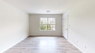 Located at 100 Cole Ln in Lawrence Township, NJ, this well-appointed two-bedroom, two-bathroom single-floor residence offers a thoughtfully designed layout with a clean, neutral aesthetic throughout. The living room features light wood-style flooring, bright white walls, and a window that invites natural light and outdoor views, creating a welcoming and airy atmosphere. A louvered closet door and thermostat add functional convenience to the space.

The kitchen is a standout feature, showcasing gray shaker-style cabinetry, white quartz countertops, a subway tile backsplash, and a full suite of stainless steel appliances including a gas range with over-the-range microwave and refrigerator. A stacked in-unit washer and dryer is conveniently integrated into the kitchen area. Light wood-style flooring ties the kitchen together with the rest of the home.

The generously sized primary bedroom is carpeted for comfort and is complemented by a private en-suite bathroom featuring a soaking tub, gray vanity, and tile flooring. The second bedroom also features carpet and ample natural light. A second full bathroom with a glass-enclosed walk-in shower serves the rest of the home. Three closets, including a spacious walk-in with wire shelving, provide excellent storage throughout.