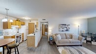Located at 28 Sterling Ridge Dr in Delaware, Ohio, this single-floor, one-bedroom, two-bathroom unit offers a thoughtfully arranged layout that maximizes every square foot. The open-concept living and kitchen area creates a welcoming hub at the heart of the home. The kitchen features warm oak cabinetry, white appliances, a peninsula with a light countertop, and a pendant chandelier above the adjacent dining area, combining practicality with charm. Hardwood-style flooring flows through the main living spaces, adding warmth and continuity.

The living room is bright and open, transitioning seamlessly into a dedicated office space accented by a calming blue-green feature wall and a natural light-filled window with sheer curtains — ideal for working from home. The spacious primary bedroom offers plush carpeting, generous closet space, and a serene, neutral palette. Two bathrooms serve the unit: one with a tub/shower combination and one with a glass-enclosed shower stall, both featuring oak vanities and clean, simple finishes.

A second carpeted room with a closet and window provides additional flexible space, currently used as an office. Textured ceilings throughout add a classic touch, while the overall layout ensures a functional and comfortable living experience.