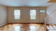 Located in the Old Forge community of Morris Plains, NJ, this two-floor residence offers 2 bedrooms and 1.5 bathrooms across a well-organized layout. Parquet hardwood flooring is a defining characteristic throughout the living areas and bedrooms, lending a classic, warm aesthetic to each room.

The main living area is bright and open, with multiple windows allowing generous natural light and a front entry door accented by decorative stained glass sidelights. A sliding glass door with vertical blinds provides access to an outdoor area, further enhancing the sense of openness. Ceiling fans are present in the living and bedroom spaces, contributing to comfort year-round.

The kitchen is efficiently designed, featuring warm oak cabinetry, granite-look countertops, white appliances including a refrigerator, electric range, built-in microwave, and dishwasher, along with a window above the sink for added natural light.

The bedrooms continue the parquet flooring theme and include closet space. The full bathroom is updated with large-format gray tile surrounding the tub and shower, while the additional half bathroom adds everyday convenience. The angled ceiling detail in one of the upper-level rooms adds architectural interest to the overall layout.