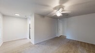 Located at 4247 5th Ave in Lake Charles, Louisiana, this single-story home offers a practical and well-organized layout comprising four bedrooms, two bathrooms, a living room, kitchen, hallway, and two closets. The living room features light hardwood-style flooring and multiple windows fitted with blinds that allow natural light to fill the space with a bright, airy feel. Each bedroom is finished with plush wall-to-wall carpeting, neutral-toned walls, and ceiling fans with light fixtures, contributing to a comfortable and consistent aesthetic throughout. Windows in the bedrooms provide views of the surrounding neighborhood and further enhance the natural lighting. The primary bedroom offers a generous footprint with direct access to adjoining spaces. The kitchen is designed with white shaker-style cabinetry, dark quartz countertops, a stainless steel undermount sink, and light wood-look tile flooring, creating a clean and modern cooking environment. Both bathrooms echo the kitchen's contemporary style, featuring white vanity cabinetry, dark quartz countertops, undermount sinks with brushed nickel fixtures, and light wood-look tile flooring. The overall design of the home is clean, cohesive, and move-in ready, with a neutral color palette that complements a variety of furnishing styles.