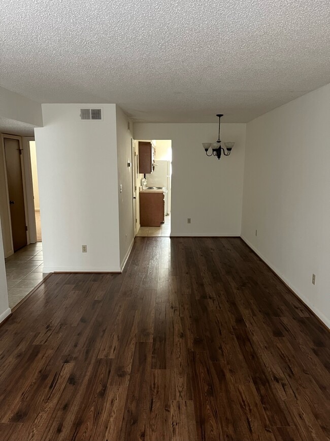 Living Area (Floors are darker in photo than person) - 1412 11th St S